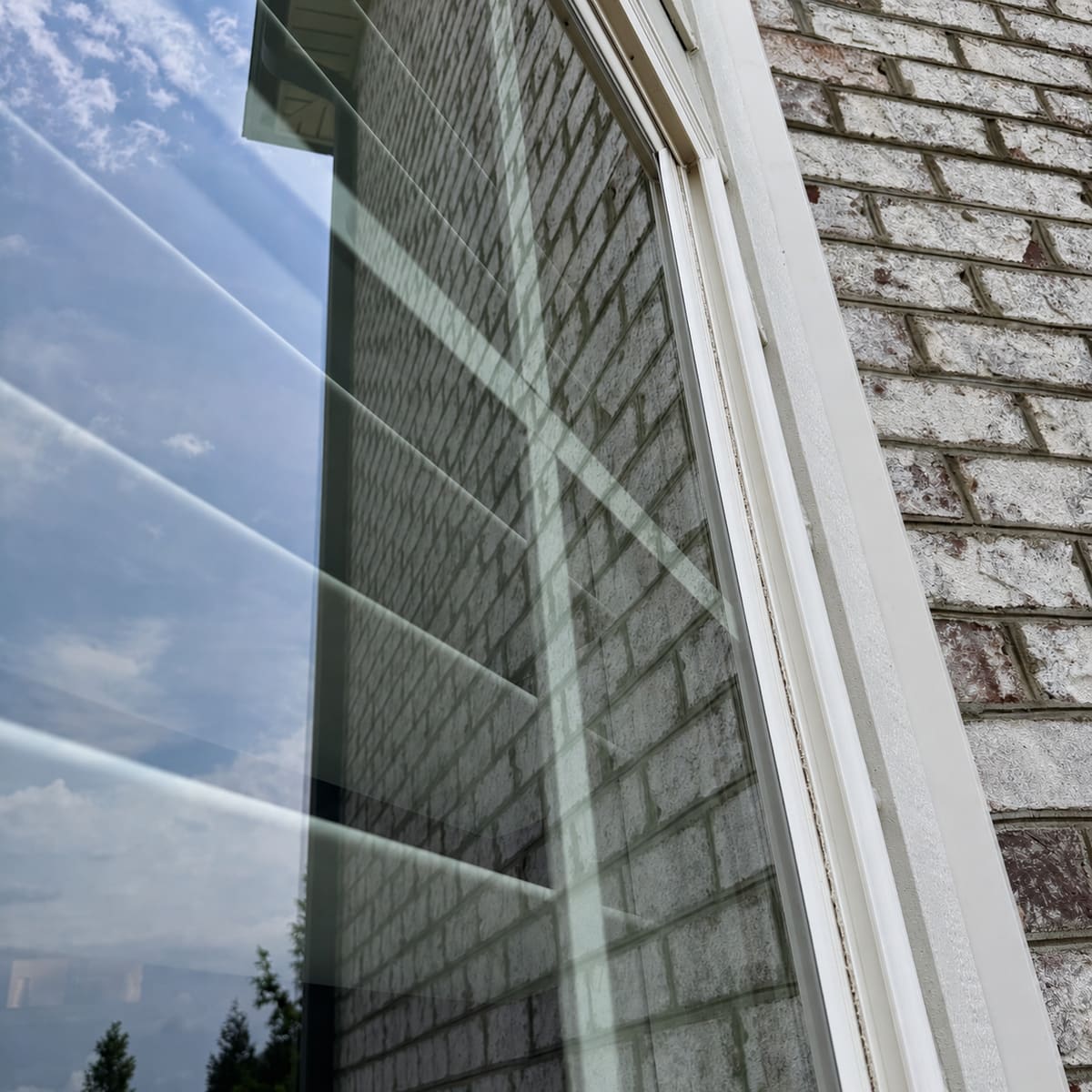 Crystal-clear window glass reflecting blue sky after a ViewPoint cleaning