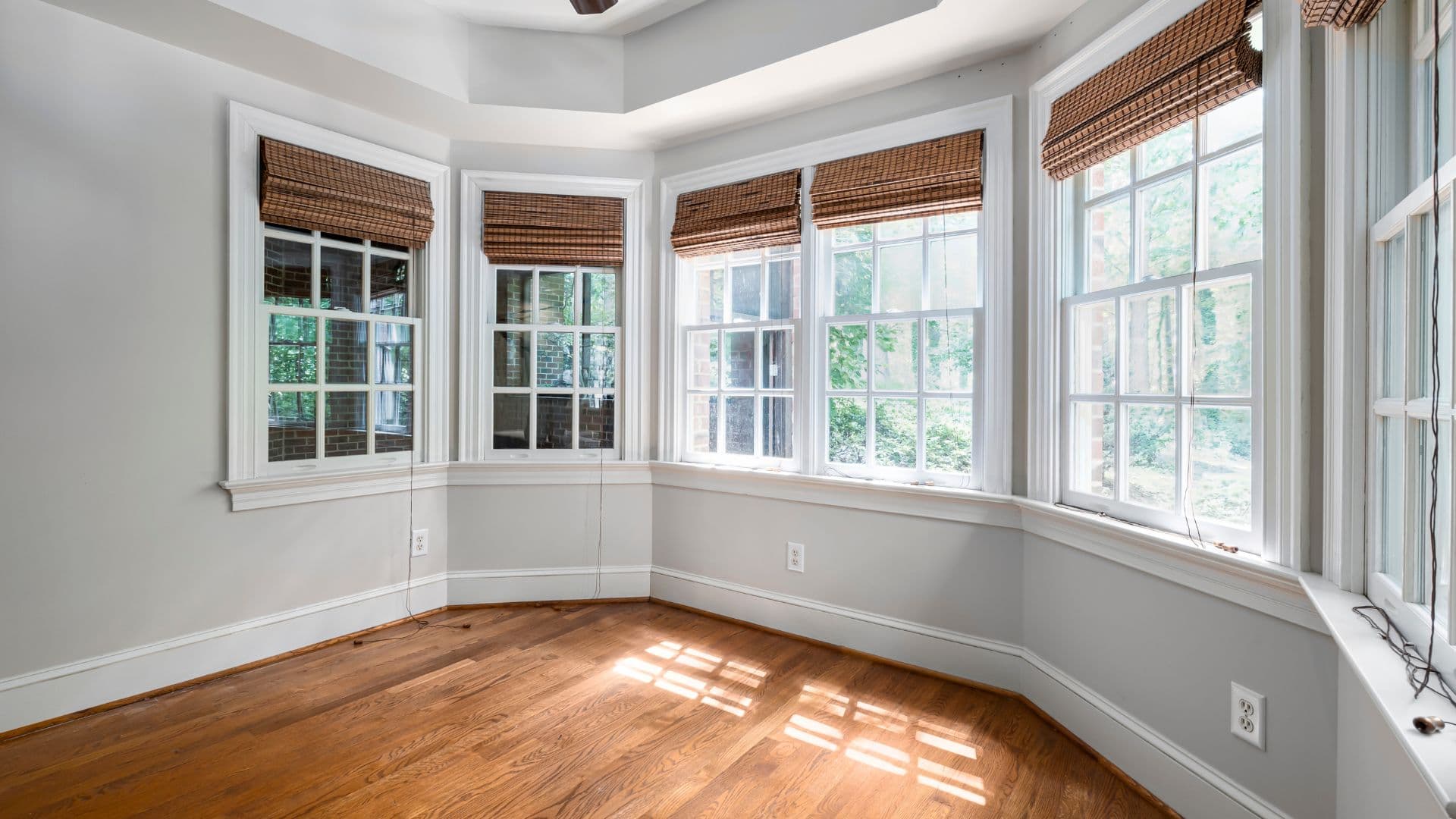 Bright sunroom with bay windows after professional interior window cleaning